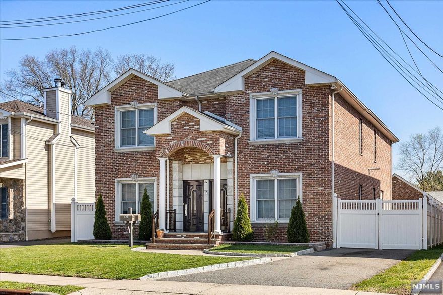 Enter into this luxurious custom built 2 family home with separate entrances, and both units having much desired open concept living. Kitchens boast upgraded custom cabinetry, lots of storage, large center island, granite countertops & ceramic tile floors. Large open dining and living space; dining room has elegantly detailed coffered ceilings. Each floor has a master suite with full bath and walk in closet, and 2 additional bedrooms with large closets. This property also offers a deep and well manicured backyard with built in raised garden beds and fruit trees; all brick oversized 2 car garage, with 5 car driveway. Laundry in each unit. Close to major highways, parks, and shopping; 1 block from NYC transit.