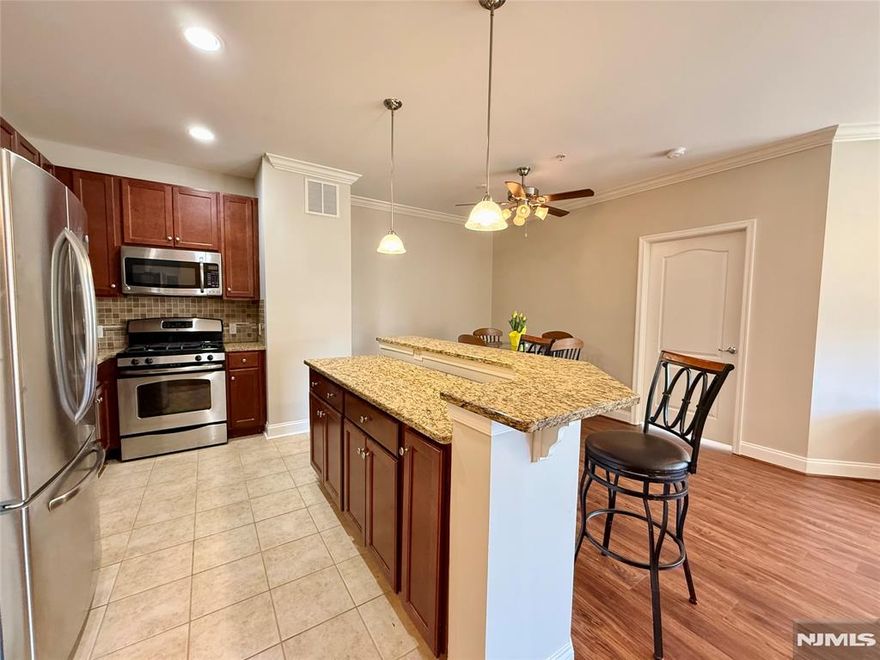 LIVE THE GRANDE LIFE! Welcome to this beautifully maintained and rarely available first-floor Kerria model offering elegant, easy living. This spacious condo features two generously sized bedrooms, each with its own walk-in close. The primary suite includes a private full bath and direct access to a charming patio overlooking the courtyard - perfect for relaxing mornings or evenings unwinding. The updated kitchen is designed for both style and function, complete with granite countertops, a center island with breakfast bar, and a pantry for additional storage. The open-concept layout flows seamlessly into the formal dining room and living areas with doorway leading to a second patio offering direct courtyard access - ideal for indoor /outdoor living. Additional highlights include a versatile office/tech nook with a convenient storage closet, full-size washer and dryer in unit, fresh paint throughout, and new laminate flooring. The hot water heater is just two years old, offering added peace of mind. This unit also includes assigned garage parking with additional outdoor parking. Residents enjoy resort-style amenities, including 2 clubhouses, 2 pools, billiards rm, tennis & basketball courts, fitness ctrs., & much more. Live the Grande lifestyle that truly has it all. A rare opportunity for first-floor living in a prime location - don't miss it!