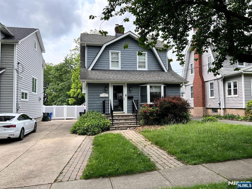 Beautifully maintained 2-story Colonial located on a picturesque, tree-lined street. This charming 3-bedroom, 2-full-bath home blends classic details with modern functionality. Rich chestnut trim throughout adds timeless character, and the wood-burning fireplace creates a cozy focal point in the living room. An open and airy layout is perfect for both everyday living and entertaining. Additional features include a finished basement, ideal for a rec room, gym, or office, plus an attic offering bonus storage or flexible living space. The private backyard boasts a spacious deck and hot tub, perfect for relaxing or entertaining. A long driveway provides ample off-street parking, along with a 1-car detached garage for added convenience. Located near major commuter routes and just minutes from train stations with direct access to NYC. A perfect blend of charm, space, and locationâ€”donâ€™t miss it!