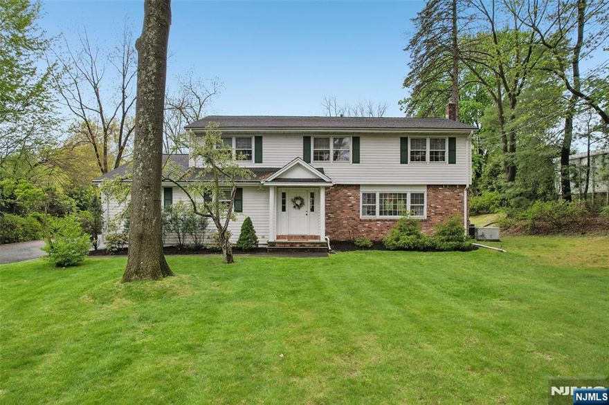 Beautiful Waterfront Setting! Welcome to this beautifully maintained Colonial home., offering timeless charm and exceptional space on a stunning 1.2 acre park like property. Built in 1965 and spanning 3200 sf, this 4 bedroom, 2.5 bath home combines classic design with serene waterfront living. A gracious entry foyer sets the tone, leading to spacious sun filled rooms enhanced by hardwood floors throughout. The expansive kitchen is the heart of the home, featuring a center island, ample cabinetry, and a bright dining area with picturesque views of the private pond, perfect for everyday living and entertaining alike. The impressive Great Room is a true highlight with a wood burning fireplace and sweeping views of the water. creating a warm and inviting atmosphere year round. Upstairs, the Primary suite offers a peaceful retreat with walk in closet and private bath, with jetted tub and stall shower. There are also three additional generously sized bedrooms and a full bath Outdoors, enjoy 125' of private waterfront surrounded by mature landscaping - your own tranquil escape just steps from your door! All this in the sought after town of Wyckoff, Close to Schools, Town and NYC Transportation. Additional features include: Whole house generator, Irrigation system, water softener and so much more... ** Only small portion of property by the pond is in flood plan*** ** No Flood insurance**