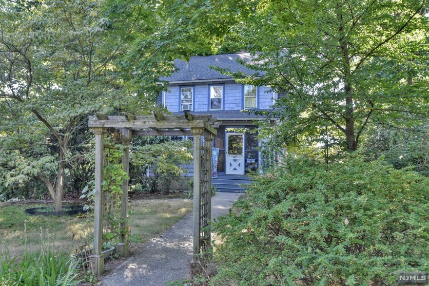 Located on a sweet, tree-lined street, this 3-bedroom, 1-1/2 bath Side Hall Colonial is being offered for the first time in over 70 years. Originally built in the late 1920's, much of this home was updated in 2011, but still retains the charm of yesteryear, including beautiful hardwood floors, high ceilings, and gorgeous wood trim. Lovely perennials, as well as mature trees, dot the generously sized yard, which also has a detached two-car garage. This home is a short distance to schools, houses of worship, parks and all that Ridgewood has to offer. Being sold strictly as is.