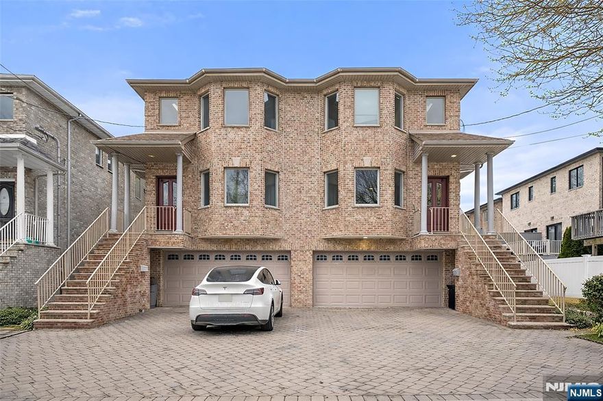 Very quiet street. The oversized duplex is situated on a 75x100 lot in a prime location in Palisades Park. This solid brick residence features three bedrooms and 3.5 bathrooms. 25% bigger than the other duplex. The property includes a spacious entrance foyer leading to a formal living room, formal dining room, and family room. The open kitchen features high-quality cabinetry and opens to a deck and a large backyard. The huge master suite includes 3 closets, a full bath, and an extra-large 2-bedroom with a full bath. Additional amenities include a two-car garage, a wide two-car driveway, three-zone baseboard heating, central air conditioning, and a central vacuum system. Walking distance to the NY bus and shopping.