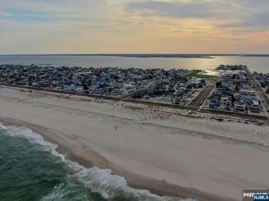 We are excited to offer a custom build in desirable Seaside Park, NJ. It is approx. 4180 square footage. This incudes a rooftop, sun deck, and various porches. The rooftop deck allows a 360° view of Barnegat Bay N, ocean, and boardwalk ferris wheel. The ground floor includes a primary suite with full kitchen, den, full bathroom & walk-in shower, lr, and a one car garage. The middle floor includes a primary suite in the front of the house on the ocean side, a junior suite, and 3 more BRs including 4 and-a-half baths. The top floor includes the an additional primary suite, 2 full baths, kitchen, living room, dining room, and two front decks with stunning views of sunset, sunrise, and ocean. Ergonomic layout on each floor. 7 1/2 baths/7 beds. Beach block in a prime location.