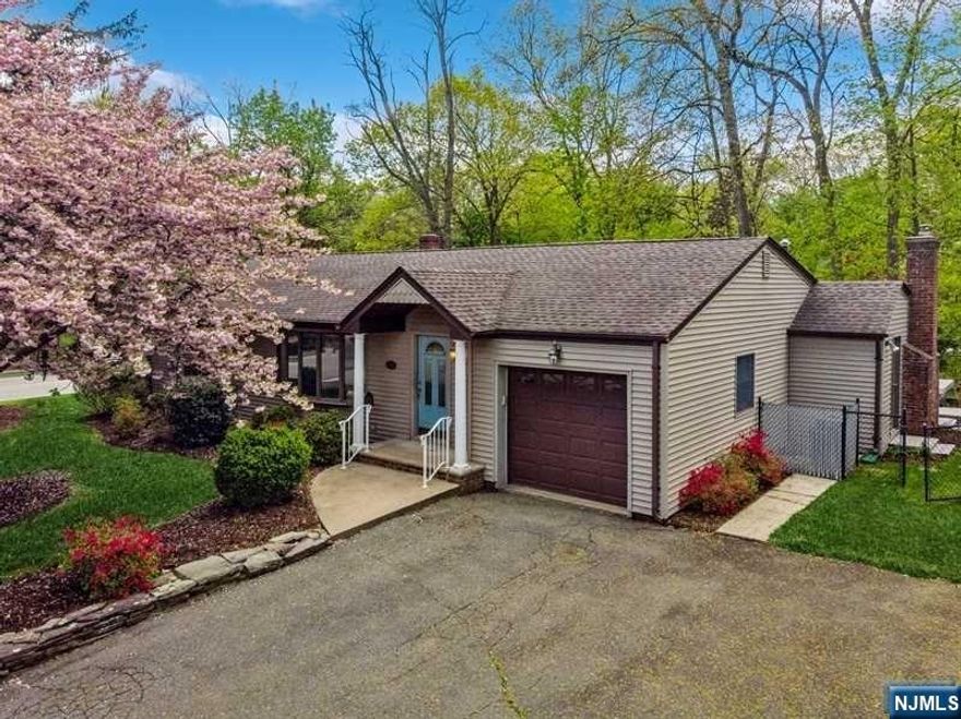 Ranch living at it's Best! This sun filled lovely well-maintained home is nestled on a level manicured, fenced-in lot. Relax on the deck or enjoy a get-together in your private backyard overlooking beautiful shrubs, plantings and flowers. The open floor plan lends itself to great entertaining possibilities. The Kitchen is a bright open space that flows into a large Family Room w/ FPL that features an incredible wall of windows through multiple sliding doors that lead out onto the deck. Two french glass doors lead to the side yard. The good sized Liv Rm has a large bay window, hard wood floors, and recessed lighting. All the bedrooms have hardwood flooring and the Primary BR has two closets and a gorgeous double window with a half round transom. Full finished basement has plenty of storage and new carpet. Close to great schools, shopping, parks, major highways, and easy commute to NYC by bus or train.