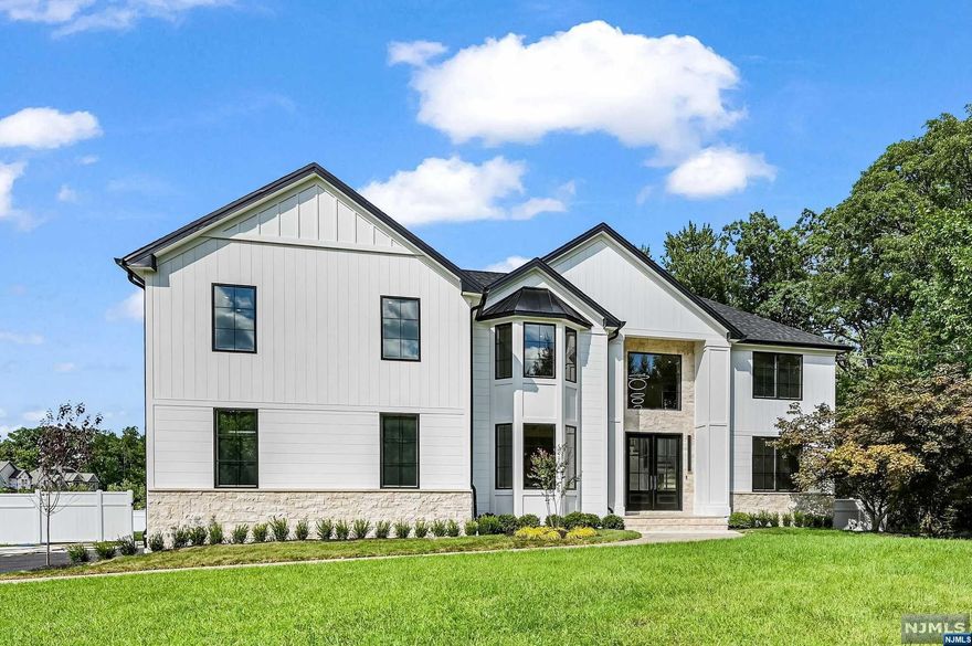 7BD 5.1BA Center Hall Colonial situated on .81-acre flat, fenced-in lot w 6000+sft living space across 3 floors. Enter through double-height lobby flanked by formal Liv rm on one side & formal Din rm on the other. The eat-in kitchen features a custom ceiling ht,. cabinets, high end appliances & quartz countertops, seamlessly flows into the Fam rm w/ inviting gas fireplace & sliders that open to an oversized deck overlooking flat fenced yard.The 1st floor features a spacious bedrm ensuite, a Pwd. rm, a mudroom, & a well-appointed laundry rm. The 2nd floor features 5 bedrooms incl. the luxurious Primary Suite serving as a private retreat, offering a spa-like bath & ample closet space. 2 bedrms share a Jack & Jill bathrm, while 2 more bedrooms are serviced by a shared bath. The fin basement features a private BD & full BA, theater rm & additional living space. Smart home features incl. Ring & Nest. 2-car garage, Close to NYC Transportation, shops & highways