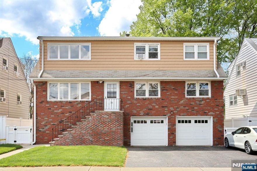 Welcome to this well-maintained two-family home, ideally situated on a quiet dead-end street with easy access to highways, mass transit, shopping, schools, parks, and houses of worship. This top/bottom property offers a fantastic opportunity for owner-occupants or investors alike. The upper unit features fresh paint, new flooring, and a spacious layout. Step through the front entrance and up to a bright, open-concept living and dining area with a large storage closet. The adjacent updated kitchen includes a brand-new refrigerator. Down the hall, you'll find three generously sized bedrooms and a renovated full bathroom. The lower unit mirrors the same functional layout and is also freshly painted. A walk-out finished basement adds additional living space and opens to a fenced backyard. Perfect for entertaining or relaxing outdoors. Additional features include off-street parking with a two-car garage and space for three more vehicles in the driveway, plus storage and laundry facilities located in the garage.