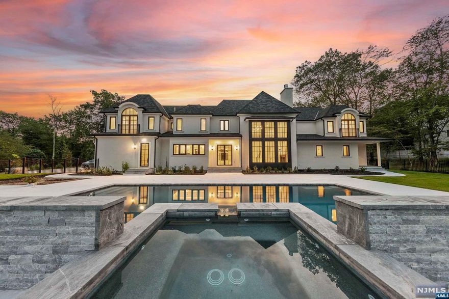 New construction, move in ready! Classic elegance, modern luxury and bespoke craftsmanship await you at this custom built Saddle River estate. Enter through the 22ft high lofty foyer with sweeping staircase open to the two story family room with floor to ceiling windows. Overlook your private resort like oasis on 2.8 acres complete with saltwater pool & spa jacuzzi. Every detail throughout embodies the highest quality sure to please the most discerning buyer. Designer chef's kitchen with Meile appliances, butler's pantry, formal dining room with wine tasting room, living room, office and 1st floor Ensuite bedroom with private entrance, radiant heat on first level. 5 Ensuite bedrooms on the second level, each with private luxury full baths. Lower level billards room, gym, theatre room, golf sim room, playroom and full bath complete approx 11,600 sq ft of living on the grandest scale. EV charger hook-up, 4 car heated garage, full brick paver driveway.