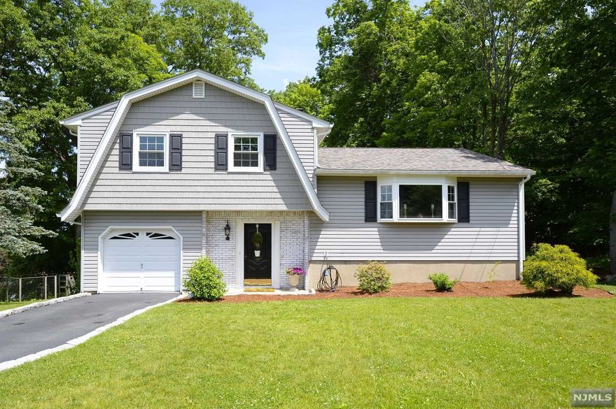 Location, location, location. Welcome to this desirable 3 bedroom split level home situated on a cul-de-sac with breathtaking mountain views! Spacious entry foyer that leads you to the family room on the ground level with access to the lower deck. Gleaming hardwood floors throughout. Oversized living room/dining room combo with sliders to the top level deck. Eat in kitchen with stainless steel appliances and Corian countertops. Master bedroom with a half bath. Updates include new windows and siding in 2014, new roof in 2020, new furnace in 2020, and new attic insulation in 2019. Full finished walk out basement with plenty of storage space. One car attached garage. Relax and enjoy the tranquility from either level of the 2 tiered deck. Private wooded lot and nicely landscaped. Great for entertaining!