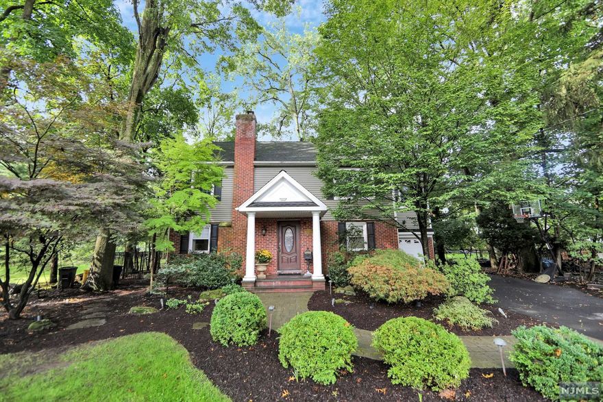 Location!! This Colonial home is located on a quiet street in the downtown area close to restaurants, stores, churches, Elementary school, and bus to NYC. Once you enter the home you will notice the open floor plan a family room with a wood burning fireplace, dining room, PR, eat in kitchen with a glass door to a HUGE private backyard, a patio with pavers then a khoya pond with fish. The second floor has a good size Laundry room with sink, full main bath with a jacuzzi tub, HUGE Master bedroom suite a huge master bath with steam shower plus 4 closets, then 2 good size bedrooms. The basement is finished with high ceilings, an office area and rec room plus a Powder room, and storage area. The home has 2 zones heat and central air, central Vac April Air, roof only 14 years old, sprinkler system and outdoor lighting and a 1 car garage to complete this home.
