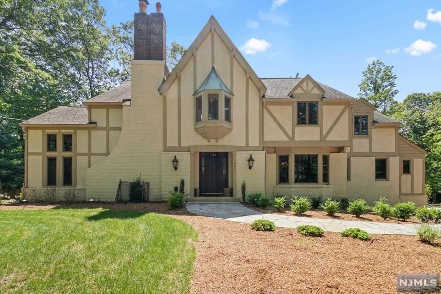 The perfect juxtaposition! Vintage Tudor charm greeted by a new super chic interior! Featuring 5 bedrooms, 3.5 total baths, finished basement,2 car garage & 1 acre property. Home has been completely updated over the course of the last 2 years including a new septic tank. Home shows like a model with all high end designer finishes. Gourmet kitchen with center island/Large Master bdrm suite with over sized WIC and island and gorgeous spa-like master bath. Large deck and yard just perfect for entertaining. Current taxes are $10,701. True pride of ownership personified in every detail!