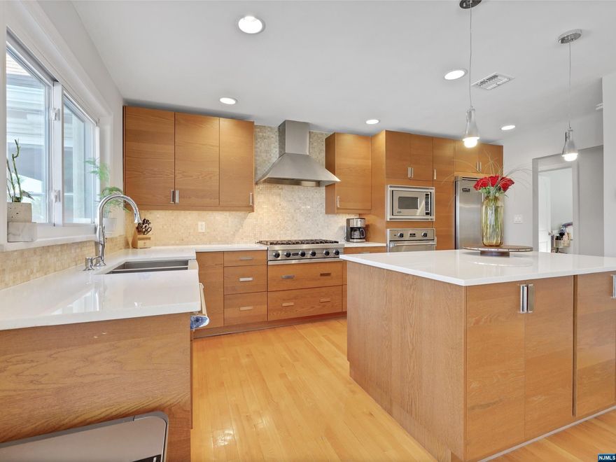 Discover this modern renovated home, with modern sophistication. Every room glows with the warmth of hardwood floors. The spacious living/family room, features stone wood-burning fireplace, is bright with large window and stunning sunsets. The stylish kitchen is a culinary dream, features oak cabinets, granite counters, a stone backsplash, and Viking appliances, including a 5-burner stove and a wine-cooler. Step from the dining room onto the large wooden deck, you can enjoy your large backyard and breath-taking sunsets. The master suite upstairs is a luxurious retreat, complete with skylights, abundant closet space, and a sumptuous tiled bath. The finished lower floor, opens to the backyard, and features s a flexible space that could be a guest suite or rec room, complete with a walk-in closet and half-bath. The large yard, featuring a patio and walk-out access. This home includes a two-car garage, central air, new furnace, remodeled roof and is 7 miles from the GW bridge.