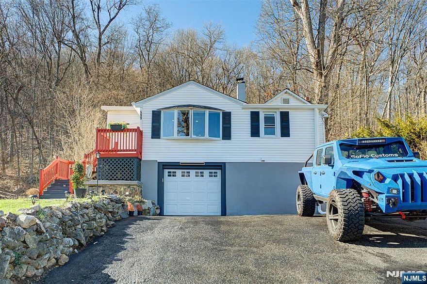 Welcome to the edge of scenic Morris County parkland, where this charming 7-room ranch offers a peaceful setting surrounded by nature while still providing convenient access to commuter Routes 15 and 80. The home welcomes you with a bright, south-facing foyer filled with windowsâ€”an ideal sunlit space for plant lovers or a relaxing sitting area. The foyer flows into a spacious living and dining room combination featuring hardwood floors, creating an inviting layout suited for both everyday living and entertaining. The primary bedroom includes a large walk-in closet, and multiple closets throughout the home provide excellent storage options. The recently updated eat-in kitchen serves as the heart of the home, showcasing granite countertops, 42-inch cabinetry, and stainless steel appliances. Just off the kitchen, the family room offers a warm and comfortable gathering space highlighted by a vaulted ceiling and a wood-burning fireplace. A versatile bonus room with a closet provides flexible space for a home office, den, or guest room. Downstairs, the basement features a wood-burning stove that can serve as an alternative whole-house heating source. Heat source is from an inside above-ground oil tank. Step outside to enjoy the patio and terraced backyard, where mature landscaping creates a beautiful setting that will come alive with color throughout the seasons.