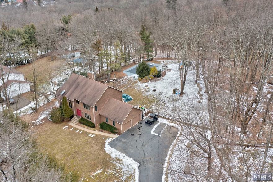 LOW LOW Taxes!! Mahwah is a superior town with an Award Winning School System. Mahwah has great skiing, hiking, golfing and plenty of outdoor activities for everyone. This Center Hall Colonial sitting on a knoll, one acre of manicured grounds, built-in heated pool and beautiful sunset views of the majestic Ramapo Mountains, will leave you breathless. Welcome to a grand 2-story foyer, vaulted family room w/ skylights, four spacious bedrooms, two and a half baths, living space of 2800 sf and LOTS of privacy. Close to all major highways, shopping and dining! Move-in ready!