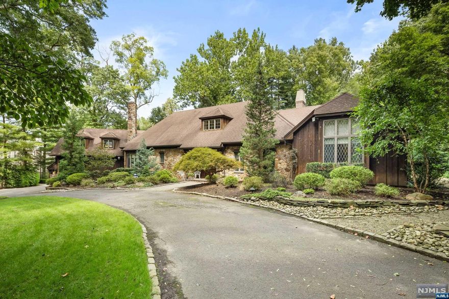 Just 7 miles from the GWB, this 5,200sf cedar and stone manor offers the perfect balance of seclusion & convenience on Demarest's East Hill. The moment you drive up the sweeping driveway, you'll be captivated by serenity. Enter through the impressive 2 story foyer and discover an expansive living room w soaring cathedral ceilings & a majestic oversized fireplace. The 1st floor is designed for both relaxation & entertainment, featuring cozy den w a striking stone & wood beam fireplace & a sunlit all-season room. Host guests in the spacious eat-in kitchen with Wolf and Sub Zero appliances, generous pantry & convenient laundry and powder rooms. Retreat to the 1st floor primary suite - a luxurious haven complete w two walk-in closets, a separate study & a spacious bath. Upstairs, you'll find 3 spacious bedrooms & 3 full bathrooms, including two en-suites. Step outside to discover your personal paradise: 2 inviting patios, hot tub & almost 2.5 acres of picturesque grounds.