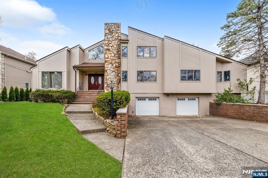 Stunningly spacious contemporary colonial on the East Side of Paramus! This large home boasts a thoughtfully designed layout, featuring 4 bedrooms, a dedicated home office, 2 full bathrooms, and 2 half bathrooms, plus a 2 car attached garage and large driveway. Step into an impressive two-story foyer highlighted by a circular staircase. The living and dining rooms offer soaring ceilings and an airy, open ambiance. The large, sun-filled kitchen includes a cozy breakfast nook with easy access to the backyard. The main level also includes a the primary suite complete with an en-suite bathroom, plus an additional bedroom and half bath. Upstairs, youâ€™ll find 2 more generously sized bedrooms, a full bathroom, &bonus room. Fully finished basement provides ample space for a rec room, along with an additional half bath & access to the attached 2 car garage. Peaceful, tree-lined neighborhood with easy access to top-rated schools, premier shopping, and all the conveniences Paramus offers.