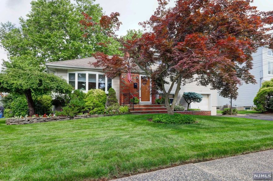 A home is where the heart is, and your heart is within this home! Great tree-lined quiet street... Wonderful curb appeal...Family room with skylights...Sliding doors to a composite deck (1 year)...Fully fenced beautiful backyard...Updated bathrooms...Updated kitchen with counter seating...A truly open floor plan...Recessed lighting...Hardwood floors, New carpets and tiles...Updated windows...Finished basement with an office. End your search for a home with this one! Minutes from transportation to NYC, steps away from parks and shopping, and a short distance to the incredible town pool and houses of worship