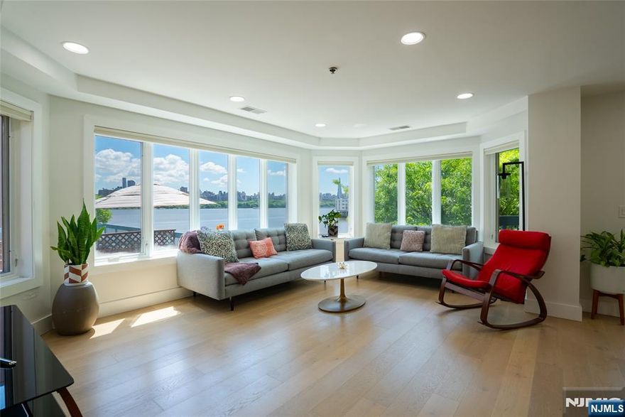 Private tours available. Experience luxury on the Hudson at 301 Stockton Court, a rare 3 bed / 2.5 bath residence offering an expansive 2,042 square feet of beautifully designed space. One of the largest homes in the coveted Independence Harbor community, this southeast-facing corner unit enjoys all-day natural light and views of Manhattan. Over 400 square feet of private outdoor spaceâ€”including a sun-drenched balcony and a generously sized patioâ€”provides the ideal setting for relaxation and entertaining. Presented in pristine condition, the home showcases a modern open-concept kitchen with quartz counters, a statement island, custom cabinetry, and high-end GE Cafe appliances. Additional features include wide-plank hardwood flooring, custom lighting, oversized closets, a spacious laundry room, central air, and gas heating, 1 outdoor and 1 garage parking spaces, and ample visitor parking. Residents enjoy premium amenities including a clubhouse, playground, 24-hour staffed gatehouse, pool, tennis courts, fitness center, and a dog run. Convenient access to public transportation and the Hudson Riverfront Walkway. Taxes and Sq Footage, etc., per NJ Tax Records, and should be independently verified.