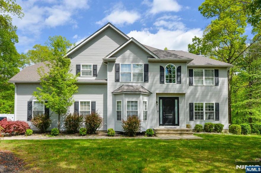 Beautiful colonial in over 1 acre of manicured property in the desirable section of Dorchester Manor! First floor: high ceilings, formal living room & dining room, two story great room w/wood burning fireplace, kitchen w/quartz countertops and separate dining area w/sliders door to deck facing wooded area. Two car garage entrance, powder room, laundry room and hardwood floors throughout! Second floor: primary bedroom suite with tray ceiling, walk-in closet, sitting area and bath with Tub and separate stall shower. Three additional bedrooms and main full bath. Attic space w/pulldown stairs for additional storage. Full unfinished walk out basement w/high ceilings.