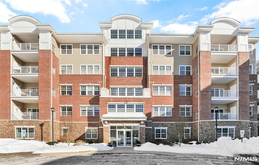 Welcome to Wanaque Reserve, a premier gated 55+ community offering resort-style living. This Westbrook model features 2 bedrooms, 2 full baths, two indoor parking spaces, same-floor storage,and a newer water heater. Hardwood flooring flows through the foyer, living and dining areas, and library/den with elegant French doors. The custom eat-in kitchen offers stainless steel appliances, granite countertops and backsplash, and abundant cabinetry. The primary suite includes a tray ceiling, two walk-in closets, dressing area, and spa-like ensuite with double vanity and large stall shower. Sliders lead to a private balcony; Levolor sunshades throughout. Enjoy a 20,000 SF clubhouse with cafe & ballroom, theater, fitness center, indoor/outdoor pools, tennis courts, and 45+ clubs and activities.