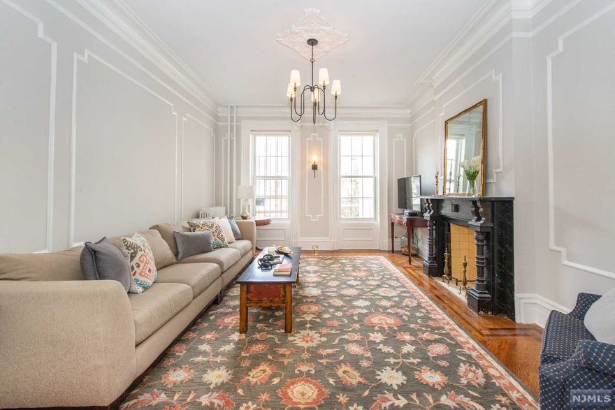Up the wide stairs & thru substantial double doors, this stunning brick fa ade brownstone in the Van Vorst Neighborhood of happening Downtown JC is sure to please; historic details on this immaculate home have been impeccably preserved & restored. Mere blocks from Van Vorst Park & Grove Street Path station to NYC, this commuter friendly location provides access to shops/restaurants /schools/JC Medical Center/Jersey Ave light rail. W/Original wood flooring, ribbon trim & moldings thru-out, this spacious home provides 5 levels of living/entertaining/storage space galore. 1st fl boasts spacious living room & sunny den (now home office). Upstairs features 2 large bedrooms/full bath. 3rd floor houses 2 peaceful bedrooms/storage area (possible bathroom/laundry). Grd fl has classic kitchen w/high end stainless steel appliances, lots of cabinetry/countertop, formal dining room & full bath. Decorative fireplaces, fin bsmt den/bath/laundry/utilities, patio & cozy yard make this the ONE!