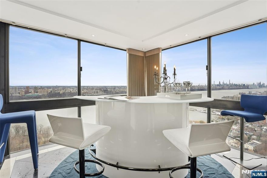 A stunning and spacious combined 2 corner-unit condo (orig. 2 Br/2 Bth + 2 Br/2 Bth, Potential to convert back into 4 Br unit) on the 30th floor offers 3 bedrooms and 2.5 bathrooms with breathtaking views of the Hudson River, Manhattan skyline, and the George Washington Bridge. Thoughtfully renovated with a sleek contemporary design, the home features elegant hardwood floors and top-of-the-line appliances. With East, South, and West-facing exposures, natural light floods the space throughout the day. Additionally, the unit includes two deeded indoor parking spaces. Enjoy the convenience of walking to downtown Fort Lee, with easy access to restaurants, parks, and more.