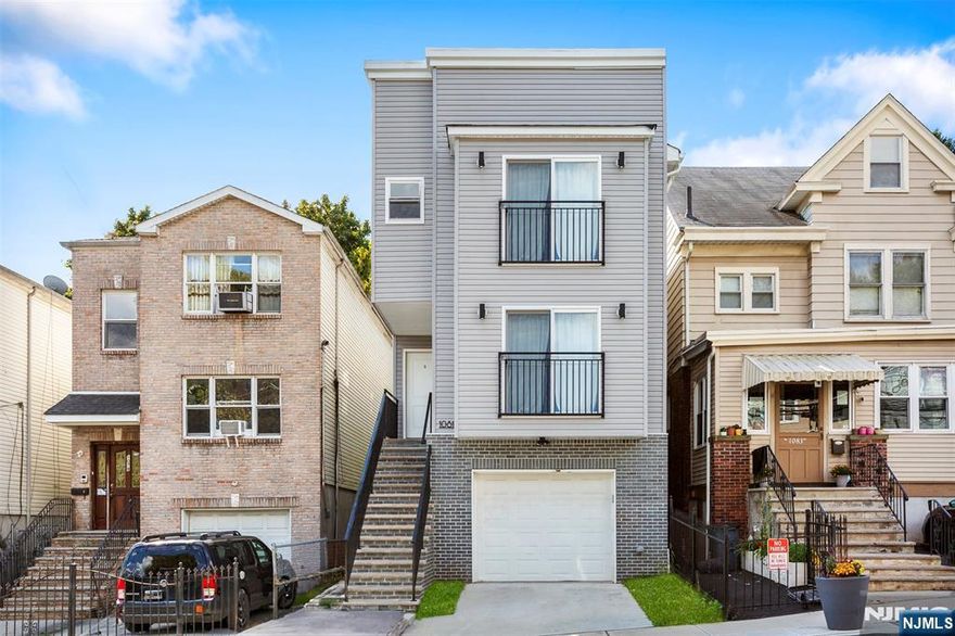 Experience this modern 2-Story home with garage in prime urban location! Welcome to this contemporary, low-maintenance home featuring a sleek exterior and thoughtful design. The property offers total of 8 bedrooms and 5 bathrooms with a private driveway leading to a built-in garage, providing convenient off-street parking. The elevated main entrance sits atop a wide staircase, adding privacy and enhancing curb appeal. Inside, the home boasts multiple levels of living space highlighted by large sliding glass doors with Juliet balconies that bring in abundant natural light. The modern facade includes clean lines, stylish gray siding, and brick accents on the lower level for a polished look. This property is ideal for homeowners or investors seeking a modern residence in a centrally located neighborhood near shops, transportation, and local amenities. Move-in ready and designed for easy living, this home offers the perfect blend of style, comfort, and convenience. Don't miss out on this exceptional opportunity!