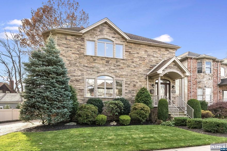 Step into this modern and elegant custom-built home on a tree-lined street in Rutherford. It's unique stone exterior is echoed inside lending soothing earth tones to the relaxing open floor plan. With 3600 sq ft of living space, this home is built for entertaining! The living room flows seamlessly into the dining room and chef's kitchen with a Viking gas range a center island and room for a table. Upstairs, discover an expansive primary suite w/vaulted ceilings, spa-like bath w/jacuzzi and steam shower, 3 more bedrooms, and laundry room. The lower level offers a large family room, summer kitchen, and separate entrance, perfect for guests. This amazing home also includes a built-in elevator, 3-zone HVAC, central vacuum, sprinkler system, paver driveway/patio, security cameras, and built-in sound system. Conveniently located near great restaurants, cafes, shops, trains and buses. Don't miss the opportunity to make this enchanting property your new home!