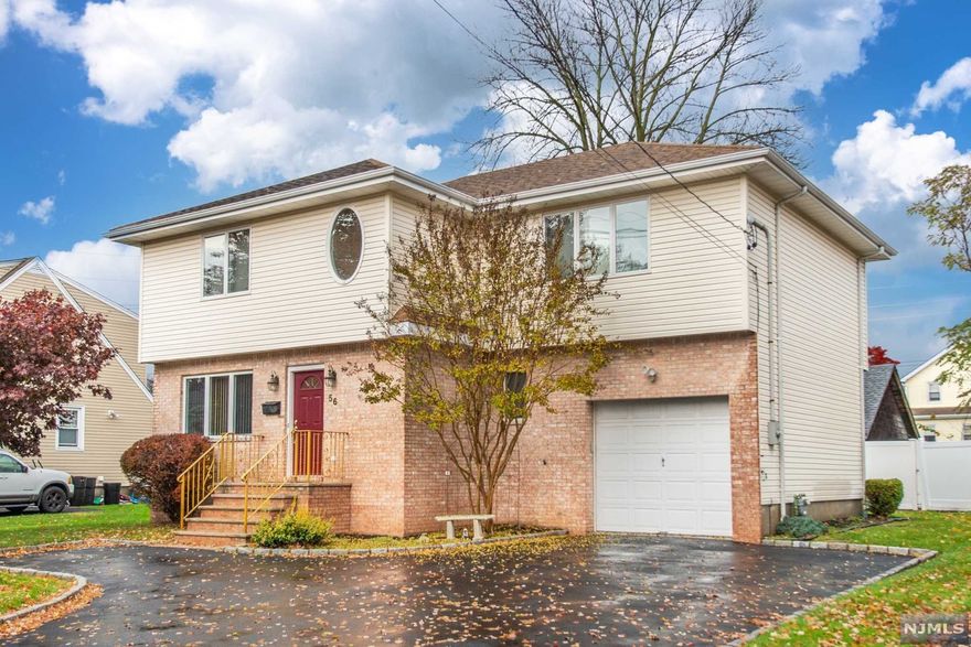 Don't blink or it will be gone. Living room and dining room with hardwood floors. Eat in kitchen with granite counters. The staircase with chandelier leads to three large bedrooms and main bath. Main bedroom with jacuzzi style tub and shower and walk in closet. 25 x 15 Mahogany deck. One car garage.Basement is finished with large storage area. Walk to shops and restaurants and NYC transportation. Short drive to major highways.