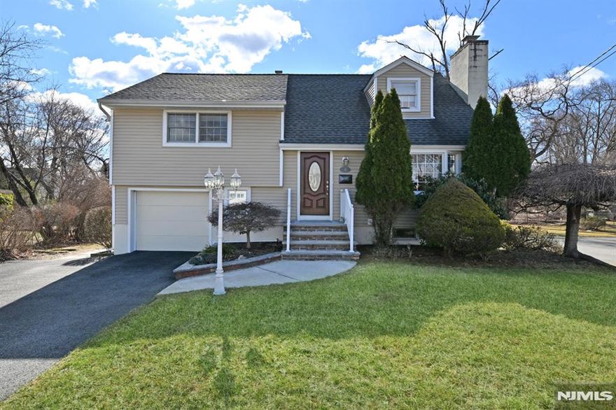 Exceptional 3 Br 2 Bath Split Level is truly in move in condition. Updated & expanded w/1,912 sf + a professionally finished basement w/wood burning FPL. So much to love including the updated 1st floor 26'x15' Great Room w/vaulted ceilings, skylights, gas FPL, pretty windows & French doors to large deck overlooking park-like yard. The Great Room is ideally located off both the Formal dining room & the beautiful MEIK w/granite counters & breakfast bar. An entry foyer welcomes you with a coat closet into the Formal Living Rm w/gas FPL & FDR Hardwood floors and Pergo floors throughout. Crown molding. 3 Fireplaces total. Central Air on 1st & 2nd floors. Window or wall a/c on 3rd floor. Ground floor perfect compluter room w/access to 1 car att gar. 2 updated, full bathrooms. Roof aprox. 6 years old. Attic fan. Located on a cul-de-sac, yet close to Shop Rite, highways, shopping, NYC bus & more. 2 tier deck ovelooks oversized property.