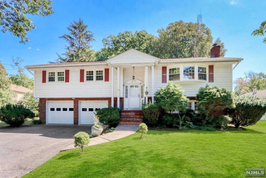 Beautiful 4-BR home with open floor plan on close to an acre of serene property. Large and bright living room, open to spacious dining room. Sliding doors that lead to an expansive deck with pergola. Luxurious eat-in kitchen featuring center island/breakfast bar, granite countertops and stainless steel appliances. Large primary suite including updated primary bath. Two spacious bedrooms and an updated full bath with double vanity completes the main level. Walk-out lower level offers a large family room with a brick fireplace. Spacious bedroom, updated full bath and laundry completes this level. Lush, professionally landscaped property offers a fenced-in backyard with large deck and covered patio--perfect for entertaining! This home is move-in ready! You will absolutely love living here!