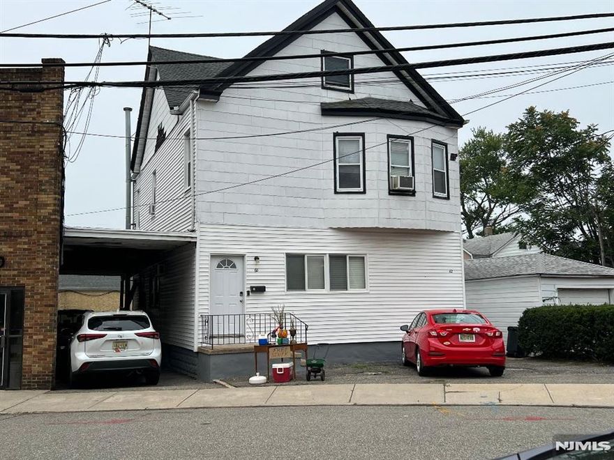 Large 2 family home conveniently located near shopping & NYC transportation! 1st floor boasts front & back entrance, Large living room, large updated eat-in-kitchen to deck, 2 good sized bedrooms (1 with walk-in closet), updated dual entry full bath & access to basement w/finished rec room, utilities & laundry. 2nd floor features large living room, eat-in-kitchen, 2 good sized bedrooms, full bath & walk-up access to finished attic storage. Other features include separate electric, gas & heat, 1 new water heater (2025), roof 10 years old, large carport (parking for 2 cars for 1st floor), 2nd floor parking in front & Wall A/C where-in. Perfect for investors or buyers who want to live in 1 unit & have unit 2 help pay the mortgage! Call today for a private showing!