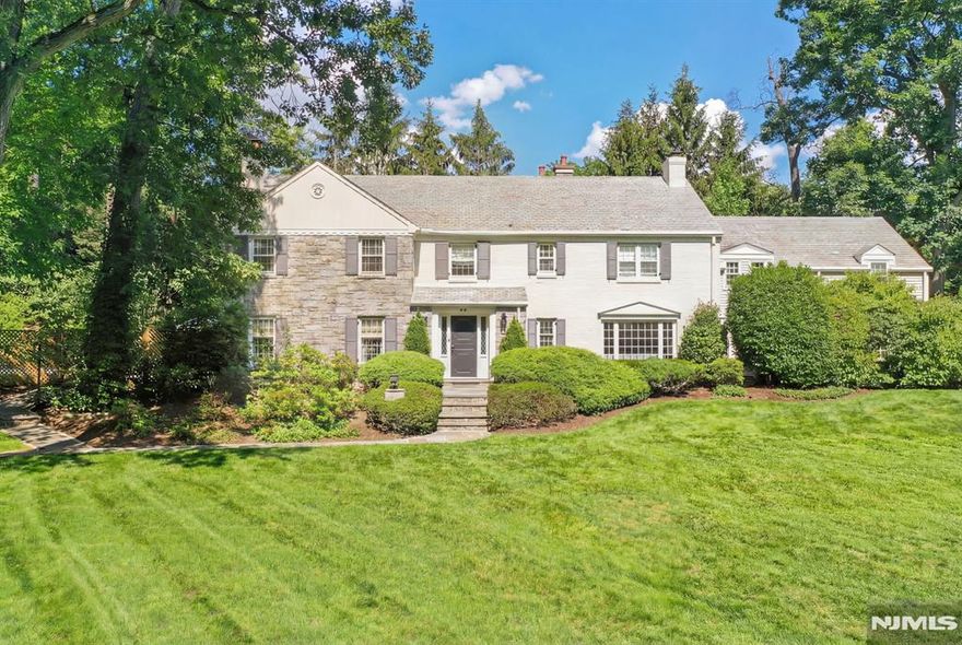 A HOME WHERE YOUR STORY THRIVES! Set on an idyllic street adjacent to Yantacaw Brook Park, this beautifully renovated gem offers a rare blend of elegance, comfort & effortless indoor-outdoor living. Stunning, fully reimagined kitchen - open, inviting, & designed for everyday life & entertaining. White marble countertops & a center island that will be the center of everything from pancakes to homework! Adjacent family room w/gas fireplace offers a seamless flow of life & light. Inviting dining room with views of patio & gardens. Fabulous living room with windows on 3 sides, built-ins, gas fireplace & French doors to patio & pool. Stately curved staircase up to Primary Ensuite with dressing room & full bath, 4 additional bedrooms, bonus room, 2 full baths & laundry room. Fully renovated lower level is a true standout - bright & thoughtfully finished with raised flooring, wool carpeting, built-in sound, climate control, & multiple windows - a stellar space for play, fitness & gathering year-round. Outside, the vibe is private retreat. A saltwater pool with gorgeous bluestone surround & retractable cover anchors a section of the backyard with plenty of fully-fenced play space beyond. Lush grounds, fish pond, waterfall, Belgian block driveway and slate roof add timeless appeal. New multi-zone HVAC. Whole-house audio, & extensive updates throughout. Space, style, and ease - just moments from parks, schools, and NYC access. More details in photo captions.