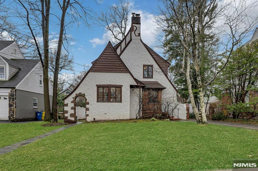 Welcome to this stunning Colonial set on a picturesque, tree-lined street in the highly desirable West Englewood section of Teaneck. Ideally located near houses of worship, parks, shopping, dining, major highways, and minutes from NYC, this exceptional home offers the perfect blend of timeless charm, space, and convenience. Step inside to a gorgeous living room featuring a wood-burning fireplace and beautiful leaded glass windows, creating a warm, inviting atmosphere filled with natural light. The living room flows seamlessly into a spacious formal dining room where the leaded glass continues, adding elegance and characterâ€”perfect for entertaining. The kitchen offers ample cabinet and counter space, stainless steel Sabbath Mode appliances, a brand new dishwasher, ceramic tile flooring, and a charming breakfast nook, with a nearby powder room. Rich hardwood floors and classic chestnut trim enhance the homeâ€™s character throughout. Upstairs, a spacious landing leads to a large primary bedroom with two cedar closets, two additional generously sized bedrooms, and a full hall bath. The third level offers a flexible office or potential fourth bedroom with skylights and storage. The basement includes a recreation area, full bath, laundry, utilities, and storage. Additional features include a detached one-car garage, private yard, and close proximity to NYC transportation. A truly special home in one of Teaneckâ€™s most sought-after neighborhoods.