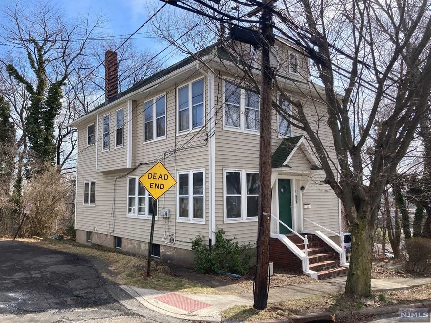 Spacious 2 family home in need of TLC but with loads of potential. 1st floor: Living room,with bonus heated porch/den area, eat-in-kitchen, 3 bedrooms and full bath (sot). 2nd floor: Living room, dining room, 2 bedrooms and full bath. Attic is sheet rocked. Basement is semi-finished, additional bath, utilities, and built-in garage. Private corner lot has large yard to enjoy with ample off street parking/storage. One gas steam boiler and hot water heater for whole house on separate Landlord gas meter, separate gas and electric meters for each apartment.