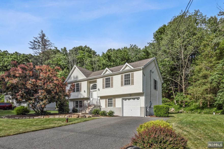 WELCOME TO THIS BEAUTIFUL 8 YEAR OLD BI-LEVEL home! Located on desirable Fountain Dr in Ringwood this home is move in ready! The main level greets you w/HW floors accenting an open LR, DR & Kitchen w/Quartz counters & SS appliances. Sliding glass doors lead to an oversize deck for entertaining & enjoying the back yard. Continue on to the primary BR w/full bath plus 2 more BR & another full bathroom. The lower level is carpeted & features a very large recreation room with/slider to the backyard. Completing this area is a half bath, laundry room with front load washer/dryer & exercise room. The 1 car garage is attached & the driveway has room for 4 cars. Close to schools, shopping and transportation!