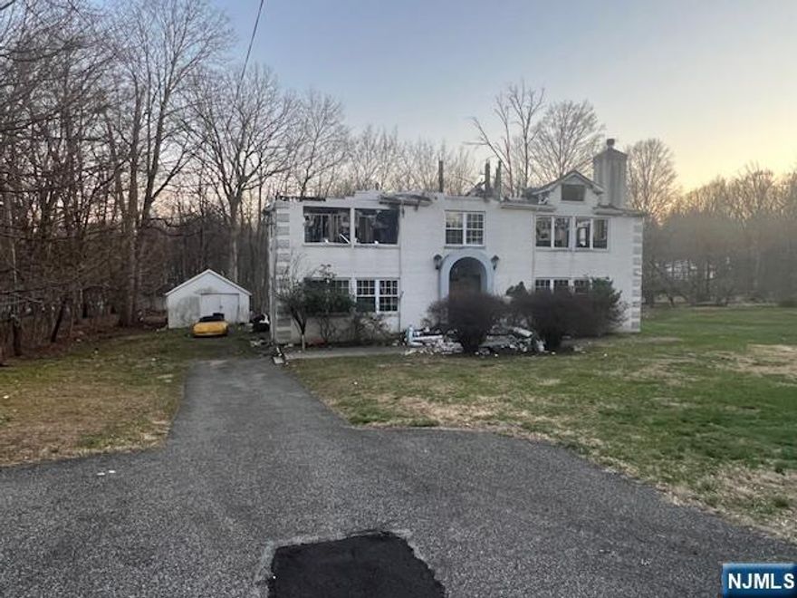 Fantastic opportunity for builders!! This is a "burn out" home with a bedroom septic system along with a separate tank to collect rain runoff from home. There is no basement or an attached garage. Architectural plans are available for remodel or new construction at cost!