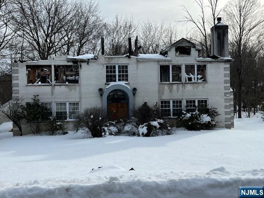 Fantastic opportunity for builders!! This is a "burn out" home with a bedroom septic system along with a separate tank to collect rain runoff from home. There is no basement or an attached garage. Architectural plans are available for remodel or new construction at cost!