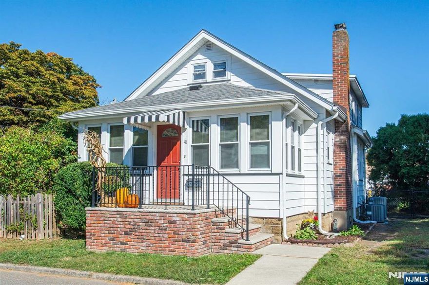 This charming home offers a spacious interior with classic, traditional details throughout. Beautiful updated hardwood floors accentuate the interior as you step into a welcoming sunroom filled with windows and natural light, leading into a large cozy living room. The formal dining room, adorned with beautiful wood trim, flows into a spacious kitchen inviting your personal touch. Along with an updated bathroom, a new stackable washer and dryer on the first floor make laundry convenient. The home boasts generously sized bedrooms, including a spacious primary, and ample closet space. The large basement offers potential for a family room or storage. Outside, the nicely sized backyard, with mature landscaping, provides a peaceful retreat. The newer roof, furnace, and 2 HVAC systems ensure peace of mind. The home is well-maintained and move-in ready. With a blend of vintage charm and contemporary upgrades, this home is perfect for those seeking character and space. A block to NYC bus.