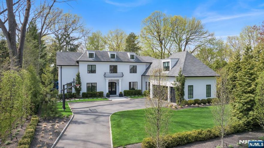 *OH Canceled SAT, May 2, 1-3PM* Set within the highly sought after Old Smith Village section on the prestigious East Hill of Tenafly, this like-new 2017 built residence defines refined turnkey luxury. Situated on a professionally landscaped 22,399 sq ft property, every detail reflects thoughtful design & high end customization. Feat 6 BDRMS, 5.2 BTHS, the home offers a bright open layout w/seamless flow. The chefs KIT boasts premium appliances, abundant storage, & opens to the inviting FAM RM, ideal for daily living & entertaining. A striking LR w/custom bar & wood beamed ceiling adds warmth, while a private office w/iron & glass doors provides a polished workspace. A well thought out MDRM w/storage & a 2nd PR off the 3 car garage. Upstairs, all BDRMS are spacious en suites. The primary suite is a true retreat w/a radiant heated marble bath, soaking tub, & oversized custom WIC. A large bonus rm offers the perfect 2nd floor FR or 6th BR, complete w/ample storage & a convenient LNDRY RM. The finished LL includes a REC RM, gym, & additional en suite BR. The backyard was newly designed for elevated entertaining w/an extended paver patio, architect designed landscaping, & a custom outdoor KIT w/Lynx appliances, bar seating & lounge space. Additional features include a Lutron smart system, Generac generator, & a 3 car garage w/epoxy flooring & 50 amp EV charger. Convenient to the GWB, top-rated schools, & houses of worship, this home offers exceptional lifestyle, design, & location