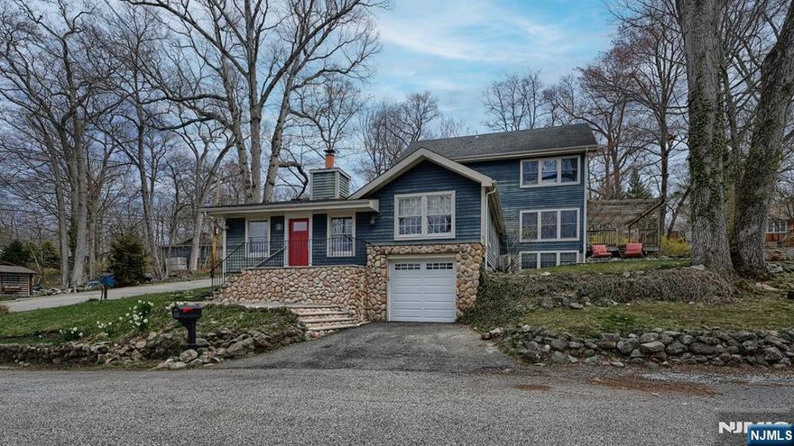 A rare blend of Pines Lake charm & modern living, this custom 4 Bedroom, 2.1 Bath home offers approx 2,500 sq ft of character-filled space. Enter into a stunning Great Rm w/ vaulted ceilings, skylights & a dramatic stone wood-burning fireplace, surrounded by natural light & access to a private courtyard. A split-bedroom layout features 2 Bedrooms w/ barreled ceilings & log walls, plus a beautifully updated shared Bath. Just steps up, enjoy a spacious Living Rm, Office area & Powder Rm. The gourmet Kitchen is appointed w/ granite countertops, SS appliances & a separate Dining area, flowing seamlessly to a custom deck w/ pergola showcasing breathtaking lake views and sunsets perfect for entertaining. Multiple patios & yard spaces enhance the outdoor experience.The top level offers a bright Primary Retreat w/ full Bath & an additional Bedroom. The ground level adds flexibility w/ Office, Rec Rm, Laundry, Mudroom, storage & access to the basement & oversized garage.Updates include newer systems & front and patio doors. Enjoy Pines Lake lifestyle w/ private beaches, boating, sailing, tennis, pickleball & scenic trails.