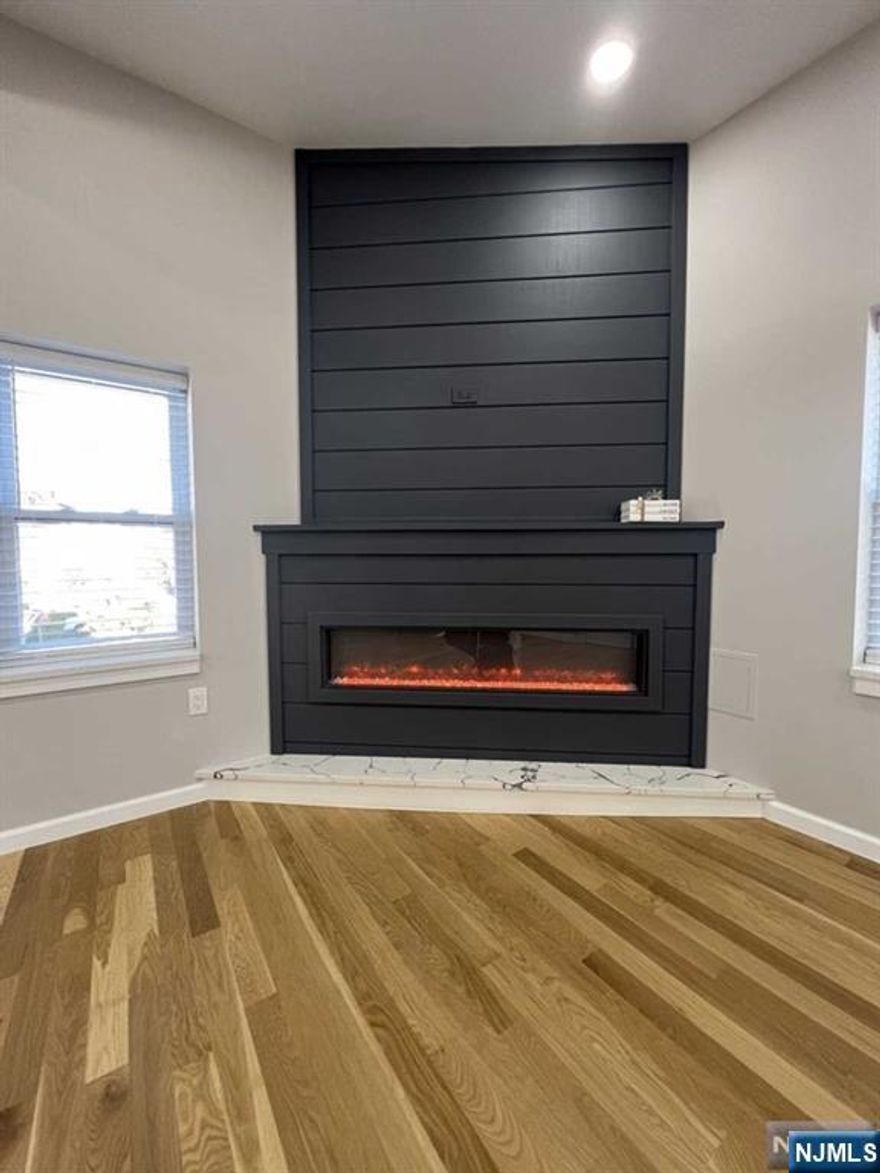 Experience luxury living in this beautifully updated 3-bedroom, 2-bathroom apartment on the 2nd floor.Upon entering, the stunning hardwood floors flow seamlessly through the open-concept living, dining, & kitchen areas, providing a warm and welcoming atmosphere. The living room features a grand fireplace, creating an inviting space for relaxation & entertainment. While the custom made barn door flows seamlessly into the master bedroom & an en-suite bathroom with modern fixtures & finishes. Two additional bedrooms are spacious & well-lit, perfect for family or guests. The second bathroom contains a stylish double vanity. A huge plus is the in-unit laundry quarters, saving you trips to the laundromat. 500 ft from the local Carlstadt K-8 public school & close to the NJ Transit bus line. Enjoy easy access to parks, shopping, & dining options. Convenient commute to NYC & access to Rt 3,17,& 21. Exterior painted Sherwin William "Iron Ore."