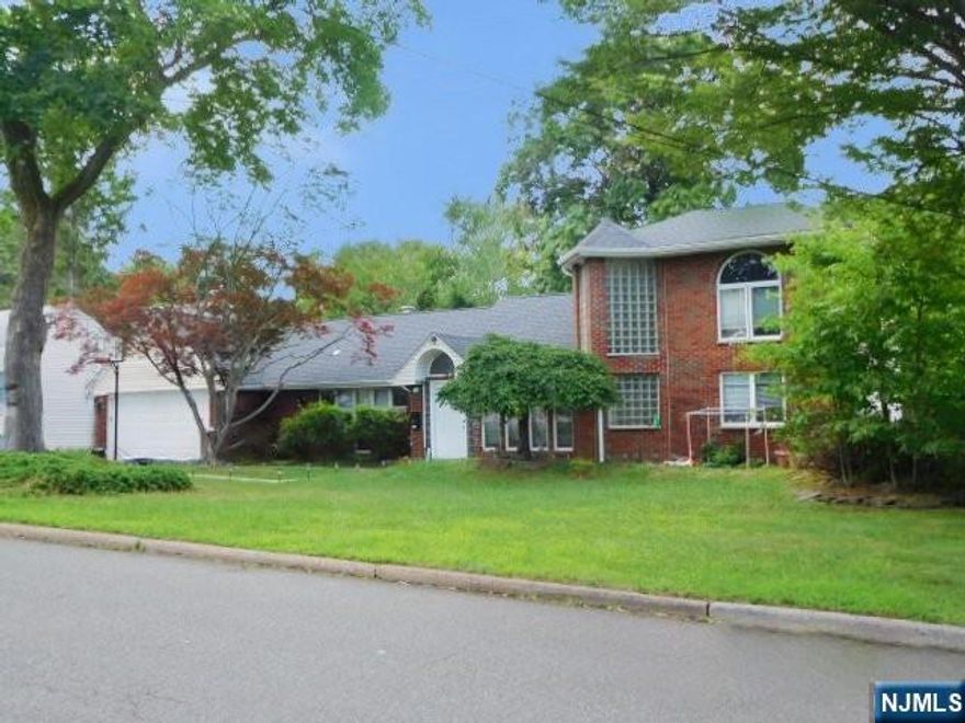 Expanded brick/frame Ranch on a 9,692 sq. ft. lot with attached garage and driveway. Features 4 bedrooms, 3 full baths, spacious living room with sliders to yard, formal dining room, updated kitchen, family room, and primary bedroom with balcony.