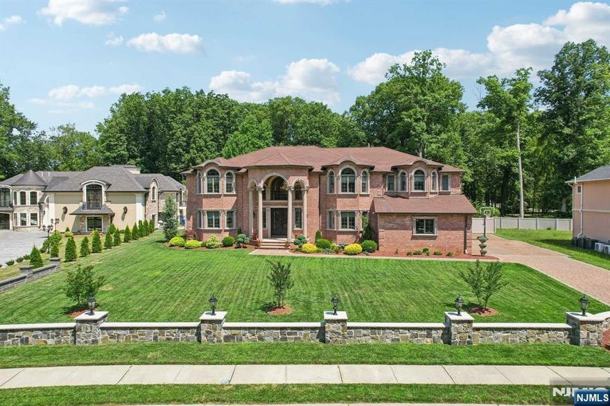 Spectacular elegant brick Colonial home built in 2017 situated on over half of an acre, Paramus rare find, boasting 5,738 sq. ft. of living space. Features radiant heat throughout, six ensuite bedrooms, a three-car garage and a sprawling backyard oasis. Enter to Grand foyer, double staircase, formal dining room with a Butlerâ€™s Pantry, living room, and a two-story family room with a fireplace. The expansive eat-in kitchen is completed with a bar and direct access to the backyard, featuring an oversized inground pool and a greenhouse. Additionally, the first floor: a bedroom with a full bath, a powder room, and an office space. Upstairs features a primary suite with a fireplace, two walk-in closets, a bathroom with a double vanity, glass shower, and a soaking tub. Additional 4 ensuite bedrooms and a laundry room. The walk-out basement is 3,061 square feet and can be easily finished. Located on the east side of town, close to schools, shopping centers, Van Saun Park, and NYC trans.