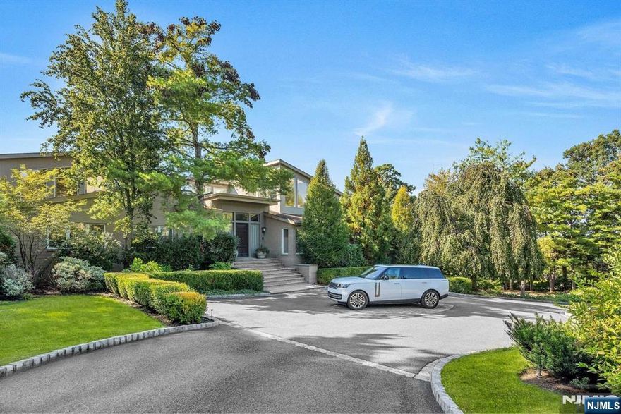 Nestled in Livingston's prestigious Chestnut Hill neighborhood, this 15,000-square-foot residence epitomizes luxury and comfort. The grand entrance leads to interiors marked by soaring ceilings and impeccable craftsmanship, embodying sophistication and grandeur. At the heart, a dream kitchen caters to culinary enthusiasts, opening into areas perfect for both lavish and intimate gatherings. The first-floor primary suite is a sanctuary of privacy, light, and luxury, featuring a decadent soaking tub, an elegant boutique-style dressing room, and a spacious sitting room/office. This home also offers a voluminous living room, a cozy fireside library, three office spaces, and four fireplaces. A 5-car garage and a lower-level designed for entertainment, including a game room, home theater, and indoor sports court, enhance its appeal. Outdoors, a large deck and free-form pool await. This bespoke residence truly embodies the essence of "There's No Place Like Home."