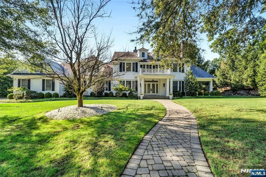 Nestled in one of the most desirable enclaves in Old Tappan, 11 O'Conners Lane presents a rare opportunity to own a residence that blends timeless elegance with modern luxury. This beautifully appointed home welcomes you with soaring ceilings, sun-filled interiors, and an effortless flow designed for both grand entertaining and intimate living. Formal dining and living rooms elevate gatherings with refined detail and sophistication. The kitchen is a true centerpiece, boasting custom cabinetry, premium granite counters, and professional-grade appliances. The kitchen opens to a covered sun deck and a fully equipped, custom outdoor BBQ. An adjoining family room with a sleek fireplace and walls of glass offers seamless access to the landscaped grounds. Retreat to the primary suite, a private sanctuary featuring a spa-inspired bath, boutique-style dressing room, and serene views. Generously scaled bedrooms, each with custom finishes, ensure comfort and privacy. All within 7,200 sq. ft. of living space, plus approximately 3,500 sq. ft. of unfinished space in the lower-level basement. With its premier location, distinguished craftsmanship, and exceptional lifestyle offerings, this residence embodies the very best of Old Tappan living.