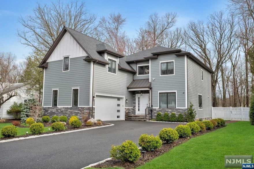 Introducing a stunning five-year-old six-bedroom, 5 1/2 bathroom house in a prime location. As you enter, you are welcomed by a grand two-story foyer adorned with beautiful woodwork, trim, and moldings. The first floor boasts 10-foot ceilings, enhancing the spacious and luxurious feel of the home. The gourmet chef kitchen features quartz countertops and a waterfall feature on the center island. Top-of-the-line appliances are perfect for meal preparation and entertaining. The open floor plan seamlessly connects the kitchen to the dining room, living room, and family room, where sliding doors lead out to the paver patio, outdoor kitchen, and expansive .39-acre flat level fenced-in property. Upstairs, you will fi nd five bedrooms, including a gorgeous master suite with a spa-like bathroom showcasing a soaking tub and stall shower. The second floor features 9-foot ceilings, adding to the airy ambiance of the home. The basement is a true entertainer's delight, complete with a wet bar.