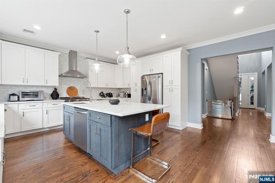 Located in one of the most sought-after areas of Bergenfield, this residence was originally crafted by one of Bergen County's premier builders with an emphasis on luxury and exceptional quality. Featuring a spacious open floor plan, it offers 5 bedrooms and 4.5 baths, including a fully finished basement, a two-car attached garage, and a private backyard designed for entertaining.The first floor showcases an eat-in kitchen with a large island, two kitchen sinks, quartz countertops, and stainless steel appliances that seamlessly flow into the family room with a fireplace. A living room, dining room, powder room, mudroom, and access to the backyard complete this level.Upstairs, you'll find 4 bedrooms and 3 bathrooms, including a primary suite with a spa-like bath featuring a freestanding tub. A convenient laundry room is also located on this floor. The finished basement includes a generous recreation area, an additional bedroom, and a full bath, offering plenty of space for guests.This home combines modern luxury with thoughtful care and attention an absolute must-see.