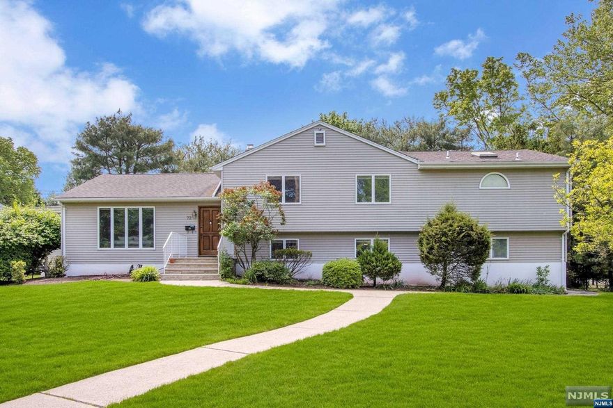 Welcome to this gorgeously expanded 5-bedroom home in the desirable Harrington Park area! With a spacious and open floor plan, this home boasts a welcoming entry foyer, a large formal living room, and a banquet-sized dining room. The expansive great room features vaulted ceilings and a custom fireplace, while the beautifully updated eat-in kitchen has vaulted ceilings and a center island, as well as sliding doors leading to the backyard. Upstairs, you'll find a luxurious primary suite with a sitting area, private balcony, and spa-like primary bath, along with two more large bedrooms and a modern full bath. The ground level has two additional spacious bedrooms, a laundry room, and access to the garage, while the finished lower level includes a recreation room, bonus room, storage, and workshop. The professionally landscaped lush property offers a large deck that's perfect for entertaining! Don't miss out on the chance to make this beautiful home yours! 5,000 sq ft !