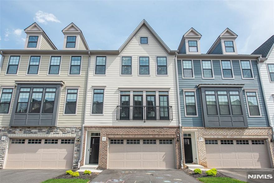 Welcome to The Grove at Upper Saddle River. This Briercliff model features extensive builder upgrades and backs to a private wooded setting. The open concept floor plan provides excellent natural lighting and is designed for both everyday living and entertaining, featuring a main-level office and a dining area with sliders to a deck. The kitchen offers a large center island, upgraded cabinetry, and full roll-out shelving for added convenience. Upstairs, the primary suite features a finished walk-in closet and a spa-like bath with a rain shower. Two additional bedrooms feature finished closets, and the hall bath includes a double sink vanity. A laundry room with added cabinetry completes the upper level. The finished lower level provides flexible living space with a recreation room that walks out to a paver patio, along with built-in shelving and space for a mini fridge. Upgrades throughout include custom hardwood flooring, iron rod railings, a stone fireplace, Sonos sound system, custom blinds, enhanced pantry shelving, and built-in garage storage. Excellent location - minutes from two train stations, bus stops, major highways, restaurants, shopping and entertainment. A perfect blend of style, function, and privacy move right in and enjoy.