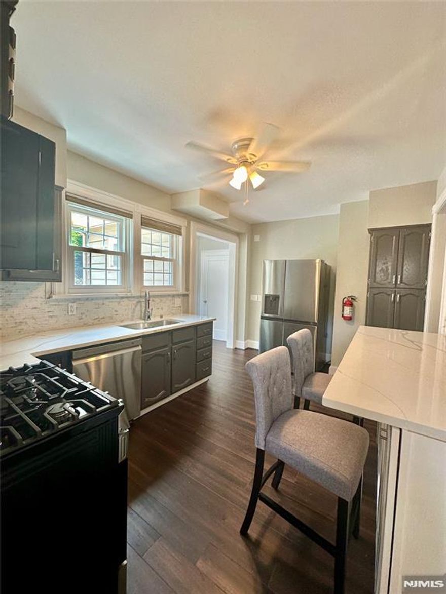 Welcome to this beautifully recently renovated 5-bedroom, 3-full-bath home located in the sought-after Fairmount section of Hackensack. This spacious Exclusive residence blends classic architectural charm with modern updates, offering sun-filled living spaces, rich flooring, elegant trim work, and an inviting layout perfect for everyday living and entertaining. The main level is quite special features bright, open rooms with large windows and thoughtful details throughout. The renovated and modern eat in kitchen boasts sleek quartz countertops, new stainless steel appliances. The updated kitchen offers sleek countertops, stainless steel appliances, and ample cabinetry. With five generously sized bedroomsâ€”including flex loft space for a home office or guest suiteâ€”and three full modern renovated bathrooms, the home easily accommodates todayâ€™s lifestyle needs. Additional highlights include a dedicated laundry area right off the kitchen, and a finished upper level with new plush carpeting. The roof is newish, the furnace is one year old and this house is being sold AS-IS. Located within the prestigious Fairmount school district and Hackensack Public School system, this home is close to NJ Transit trains, bus transportation, shopping, and a variety of excellent restaurants and cafes, offering the perfect blend of convenience and neighborhood charm. Welcome to your dream home.